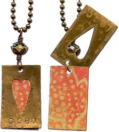 two necklaces with different designs on them, one in gold and the other in red