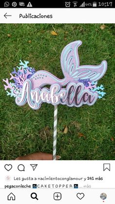 a cake topper that is sitting in the grass