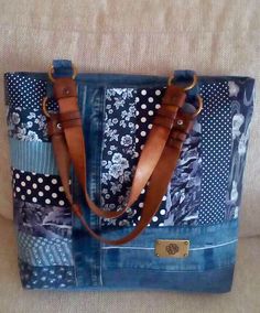 a blue and white tote bag sitting on top of a couch