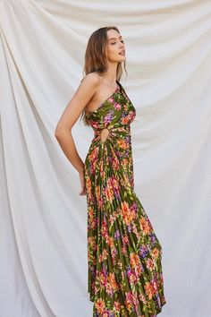 Get ready to turn heads in our stunning Cleopatra Garden Party Dress. Made with luxurious green floral satin, this dress features an eye-catching pleated and asymmetric design with a daring side cutout detail. Effortlessly stunning, pair it with a simple heel and statement earrings for a show-stopping look. Don't be surprised if you become the life of the party! Multi color floral satin Pleated design One shoulder with keyhole at the side Invisible side zipper The material is 100% Polyester. The Cleopatra Dress, Willow Garden, Garden Party Dress, Pleated Maxi Dress, Pleated Maxi, Asymmetrical Design, Dress Trousers, Bottom Clothes, Clothes Collection