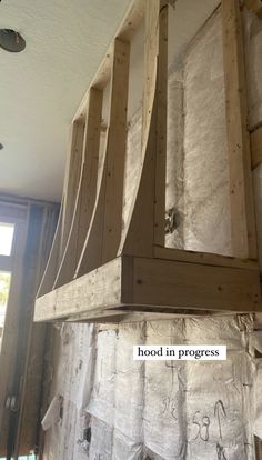 an unfinished kitchen hood in progress with the words'wood in progress'written on it