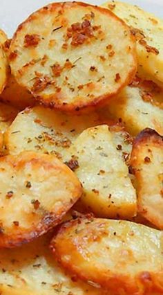 some potatoes are sitting on a plate with seasoning sprinkled on them and ready to be eaten