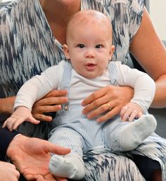 a woman holding a baby in her lap