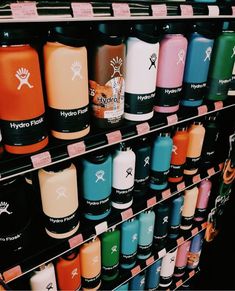 many different types of hydro flasks are on display for sale in a store