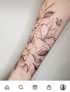 an arm tattoo with flowers on it