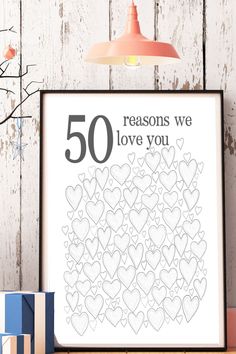 a poster with the words 50 reasons we love you on it next to some presents