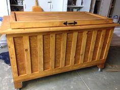 a wooden chest sitting on top of a hard wood floor