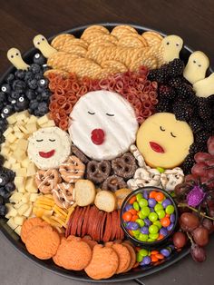 a platter filled with lots of different types of snacks and candies on top of it