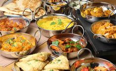 a table filled with lots of different types of food on it's trays