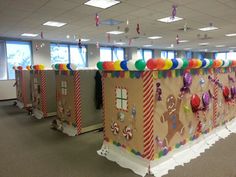 an office decorated for christmas with gingerbread houses and candy canes on the walls