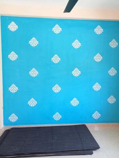 a blue wall with white designs on it