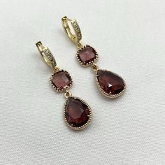 Burgundy Crystal Earrings  Teardrop Earrings Huggie Rhinestone Earrings Maroon Glass Earrings Handmade Jewelry Art Deco Jewelry Wine Red Earrings Glass Plum Purple Glass Earrings Red Burgundy Beaded Earrings Garnet Earrings Handmade Earrings Gift for Her Gift for Mom Divine design Burgundy Crystal Glass Teardrop Dangle Earrings handmade by me.  DETAILS OF THE EARRINGS: *Gold Bronze Trimmed Burgundy/Wine/Maroon Coloured Glass Teardrop Shaped Charms.   *Gold Bronze Trimmed Burgundy/ Wine/Maroon Cr Deco Earrings, Teardrop Dangle Earrings, Garnet Earrings, Burgundy Wine, Earrings Red, Art Deco Earrings, Red Earrings, Purple Glass, Art Deco Jewelry