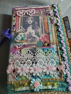 an altered book is decorated with lace and flowers