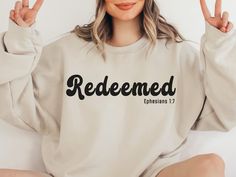 "Our Redeemed Christian sweatshirt is more than just a piece of clothing; it's a powerful statement of faith and a reminder of the immense joy and comfort one can find in their relationship with Jesus. This cozy sweatshirt is designed with a comfortable fit and made from a high-quality blend of materials, ensuring both warmth and durability. All of our shirts are made with the highest quality materials and are super soft and cozy! HOW TO ORDER  1. Check our photos for sizing and color options.  2. Choose your quantity. Feel free to add as many shirts as you wish!  3. Select your size and color from the drop-down menus.  4. Click \"ADD TO CART\" to add the shirt to your virtual cart.  5. Click \"PROCEED TO CHECKOUT\" to purchase your shirt.  6. Your shirt is now off to production! We will p Hope Shirt Designs, Christian Sweaters For Women, Christian Cricut Shirts, Christian Vinyl Shirts, Shirt Designs Ideas, Christian Sweaters, Bible Shirts, Bible Verse Svg, Christian Shirts Designs