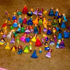 there are many princess figurines on the floor