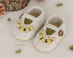 a pair of crocheted baby shoes sitting on top of a table