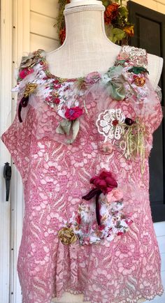 a mannequin wearing a pink top with flowers on it