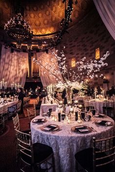 an elegantly decorated banquet hall with round tables