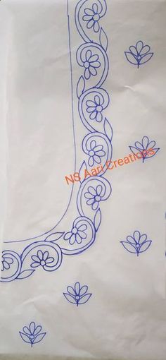 a piece of white paper with blue embroidery on it