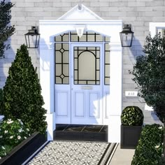 a white front door surrounded by potted trees and bushes with lanterns on the side