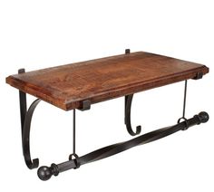 an iron and wood shelf with two hooks on each end, holding a wooden table