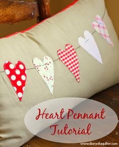 a pillow that has hearts on it and the words, heart pennant tutor written in red