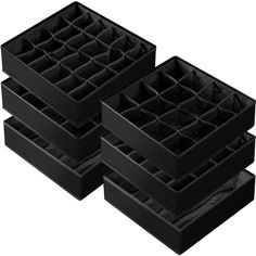 three black boxes with dividers on each side and one in the middle filled with compartments