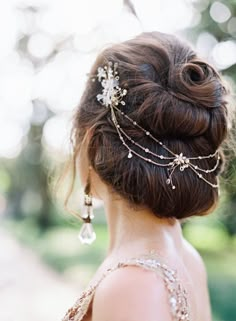 the back of a woman's head wearing a hair comb with pearls and crystals