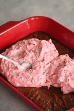 a red bowl filled with ice cream on top of a table