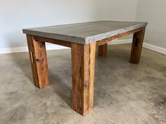 a wooden table sitting on top of a cement floor