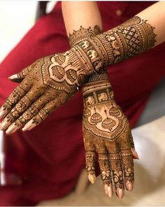 two hands with henna designs on them