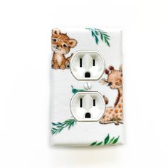 a white light switch cover with giraffes and baby animals on it's side