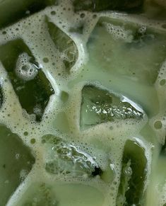 green liquid is being mixed together with other items to make an ice cream treat or dessert