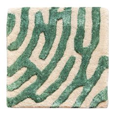 a green and white rug with wavy lines on the bottom, in front of a white background