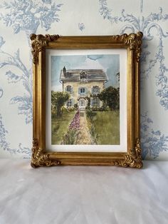 a painting of a house in the middle of a wall with blue and white flowers on it