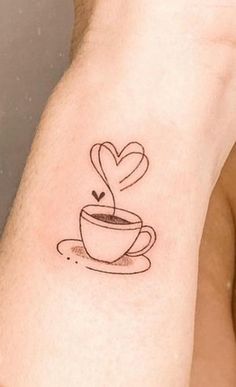 a tattoo on the arm of a man with a coffee cup and heart in it