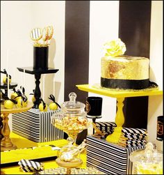 a table topped with yellow and black desserts