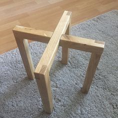 two wooden benches sitting on top of a carpeted floor next to a wood floor