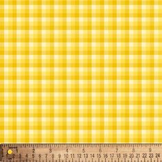 a ruler is next to a yellow and white checkered fabric