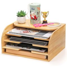 a wooden magazine rack with magazines on it and a cup sitting on top of it