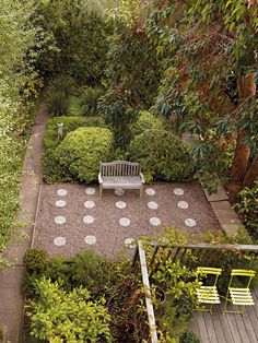 an aerial view of a garden with a bench