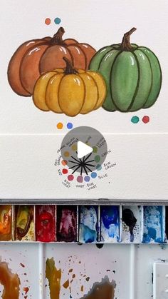 an artist's palette with watercolors and pumpkins painted on the wall