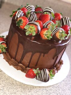 a chocolate covered cake with strawberries on top