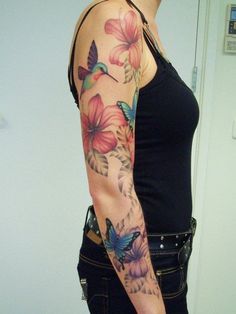 a woman's arm with flowers and butterflies on it