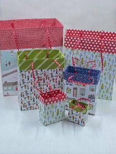 four small gift bags in different patterns and designs