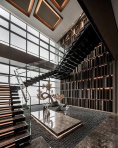 a living room filled with lots of furniture next to a stair case