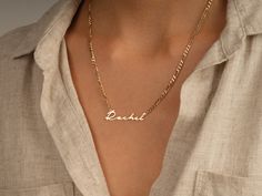 This 14k solid gold name necklace is made from a dainty, yet chic flat figaro chain. Its beautiful finish shines against your skin to accentuate your beauty. Don't forget to choose the best length that works for you! FEATURES • Material: 14k Solid Gold (Stamped 14K for authenticity) • Color Options: Yellow Gold • Chain Style: Flat Figaro Chain • Chain Width: 3.00 mm • Clasp Type: Lobster Clasp • Available Lengths: 14", 15", 16", 17", 18", 19", 20" For custom lengths feel free to contact us. We c Elegant Custom Nameplate Chain Necklace, Classic Gold Name Necklace With Delicate Chain, Elegant Name Pendant Chain Necklace, Elegant Pendant Chain Necklace With Name, Elegant Personalized Yellow Gold Chain Necklace, Elegant Custom Name Chain Necklace, Figaro Chain Nameplate Jewelry For Anniversary, Anniversary Silver Name Necklace With Figaro Chain, Elegant Gold Chain Necklace With Custom Name