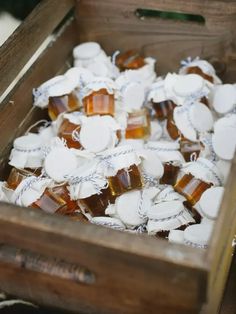 a wooden box filled with lots of white and brown pieces of gummy bear candies