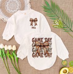 Personalised Game Day Baby Romper, Vintage Coquette Football Bow Romper Sweatshirt, Football Sport Baby Outfit, Matching Baby Outfits - Handmade  - Ships from USA  - Materials: 100% CPSIA Compliant and Ethically Made material Light fabric (5.0 oz/yd² (170 g/m  Crafted with soft, breathable fabric, this romper ensures your baby stays comfortable through playtimes and nap times alike. Featuring charming designs suitable for all babies, our romper is as adorable as it is practical.  Quick Sizing Ti Graphic Print Long Sleeve Top For First Birthday, White Long Sleeve Tops For First Birthday, White Tops With Name Print For Playtime, Matching Baby Outfits, Nap Times, Personalized Baby Shower Gifts, Outfit Matching, Sports Baby, Girls Coming Home Outfit