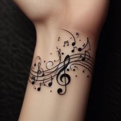 a wrist tattoo with musical notes on it